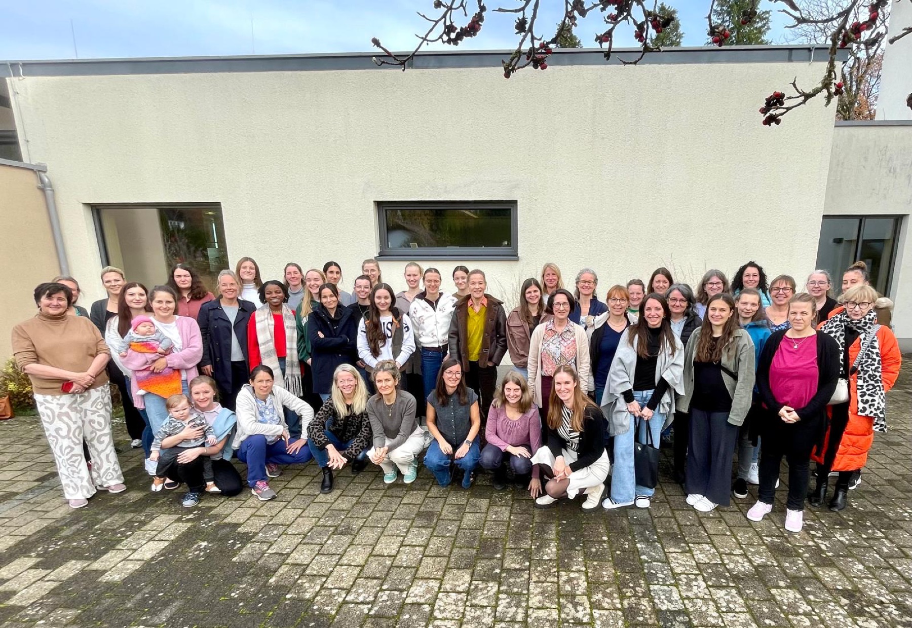 Viele Frauen stehen für ein Gruppenfoto zusammen.